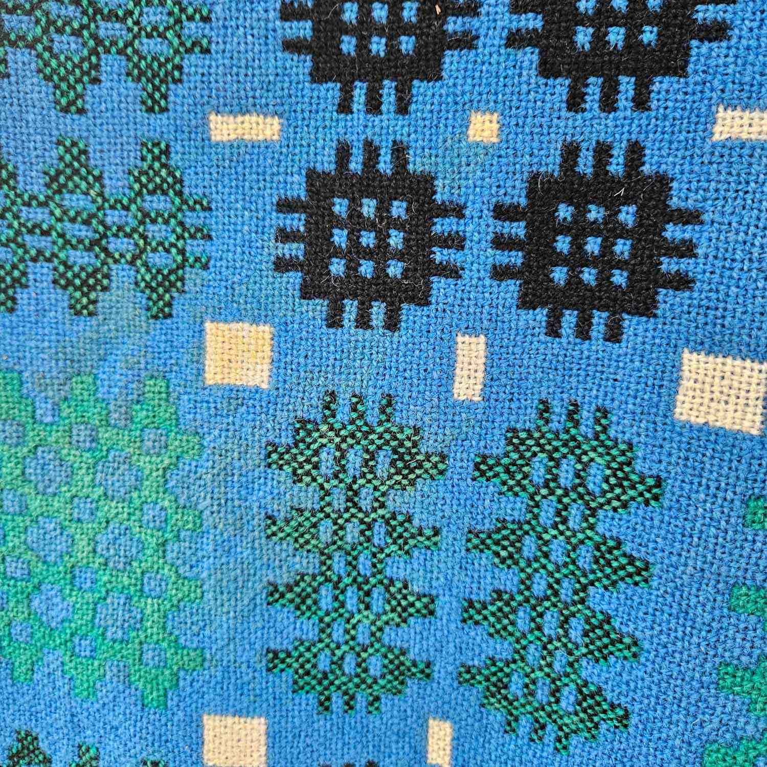 Vintage Welsh blanket in blue, green, cream, and black