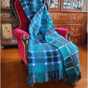 Vintage Welsh blanket in blue, green, cream, and black